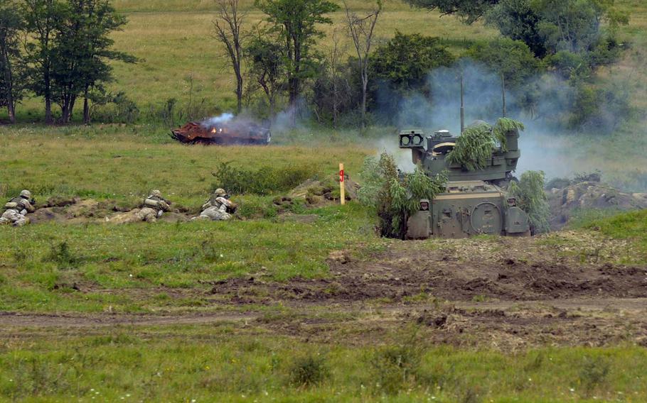 A Bradley fighting vehicle fires on a target during a live-fire demonstration at the Center for Joint National Training in Cincu, Romania, Saturday, July 15, 2017. The demonstration was part of the U. S. Army Europe-led exercise Saber Guardian 2017.