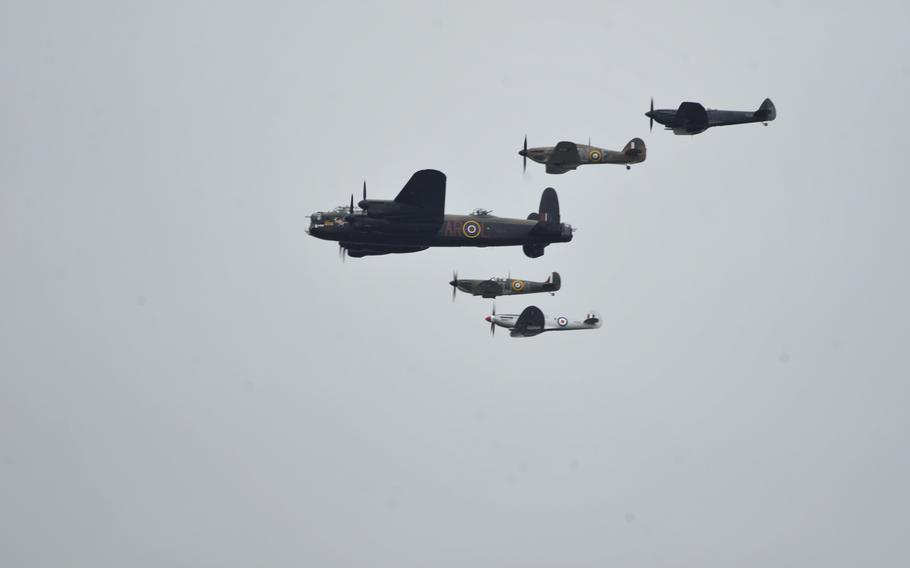 A Royal Air Force Lancaster Mk. 1 and various Supermarine Spitfires fly in a Battle of Britain heritage flight during the Royal International Air Tattoo at RAF Fairford, Saturday, July 15, 2017.