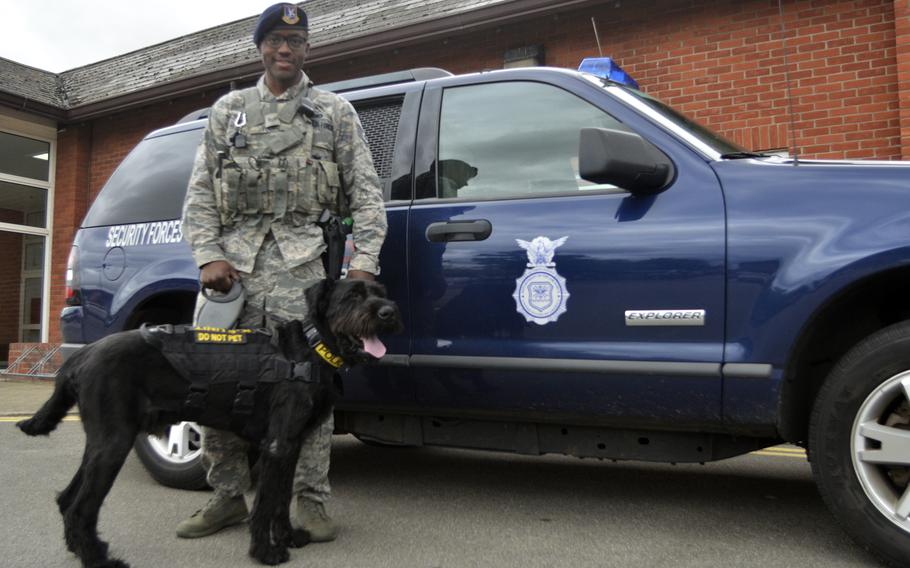Staff Sgt. Dominick Young, dog handler, 100th Security Forces Squadron, with his partner Brock the giant schnauzer at RAF Mildenhall, England, Friday, July 28, 2017. 