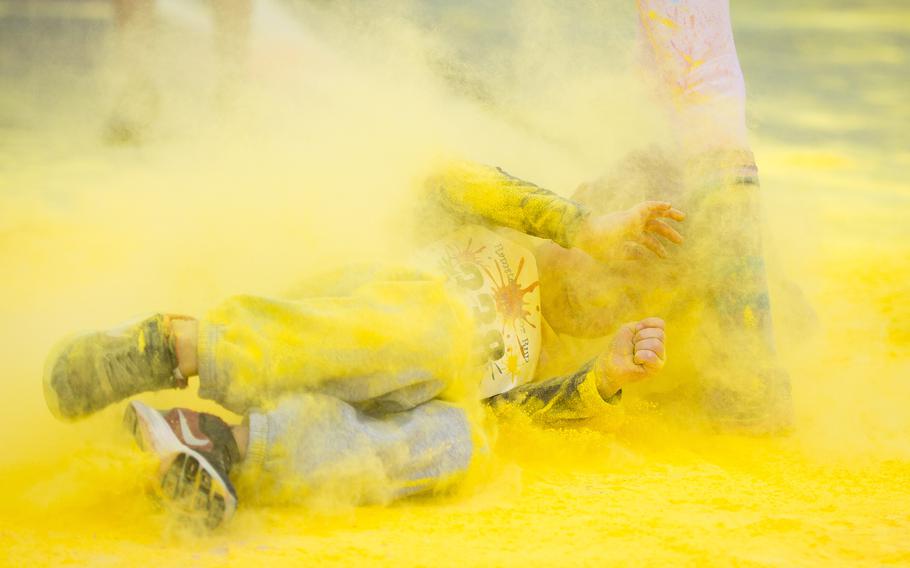 A boy rolls through colored powder during the annual Color Run at Ramstein Air Base, Germany, on Saturday, Aug. 12, 2017.

