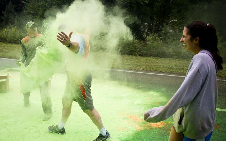 A participant gets a bag of colored powder thrown on him during the Color Run at Ramstein Air Base, Germany, on Saturday, Aug. 12, 2017.

