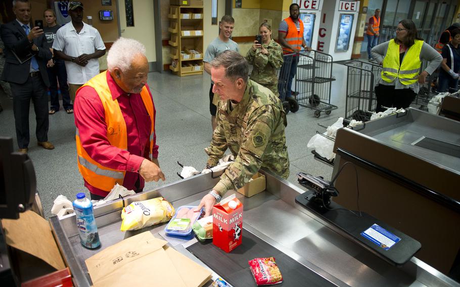 Air Force Chief of Staff Gen. David Goldfein, right, and Charlie Searchwell bag groceries at Ramstein Air Base, Germany, on Monday, Aug. 21, 2017. When Goldfein was a teenager he bagged groceries for Searchwell at the commissary.

