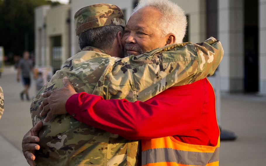Charlie Searchwell, right, and Air Force Chief of Staff Gen. David Goldfein hug in front of the commissary at Ramstein Air Base, Germany, on Monday, Aug. 21, 2017. Searchwell was Goldfein's first boss when he bagged groceries as a teenager.

