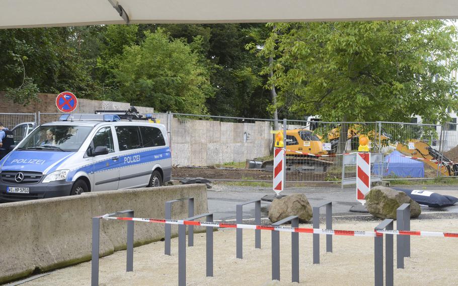 The area around an unexploded 1.8-ton bomb from World War II is blocked off by tape and fences, along with a detachment of polizei, on the west end of Frankfurt, Germany, Thursday, Aug. 31, 2017. 