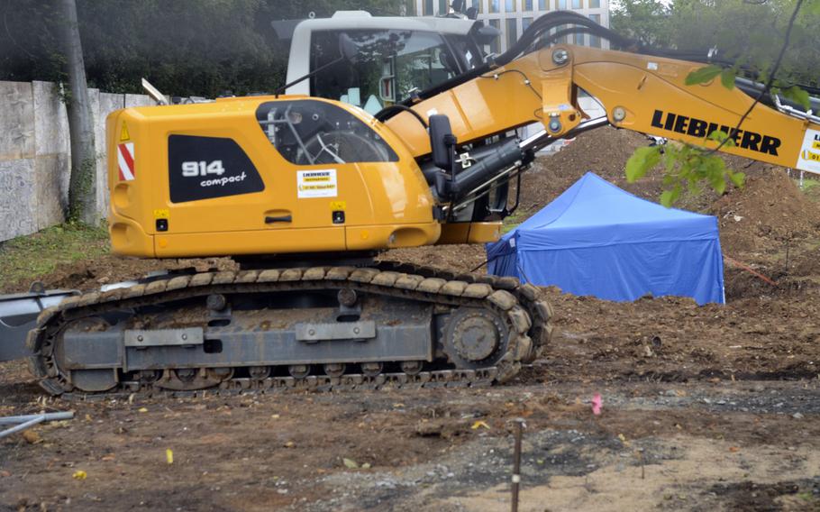An unexploded 1.8-ton bomb from World War II is covered by a blue tent at a construction site on the west end of Frankfurt, Germany, on Thursday, Aug. 31, 2017.