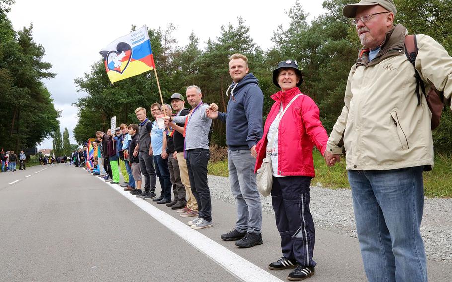 Protesters at Ramstein Air Base in Germany link hands on Sept. 9, 2017, during demonstrations against operations at the base.
