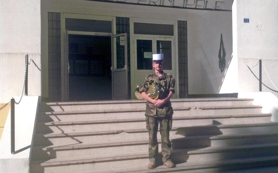 Timothy Cool, an American serving in the French Foreign Legion, stands in front of the building housing the Legion's marching band. The 27-year-old from Menash, Wis., is completing his five-year of duty and has already re-upped. "We're musicians but we're also combat soldiers - not just pretend soldiers," he said.