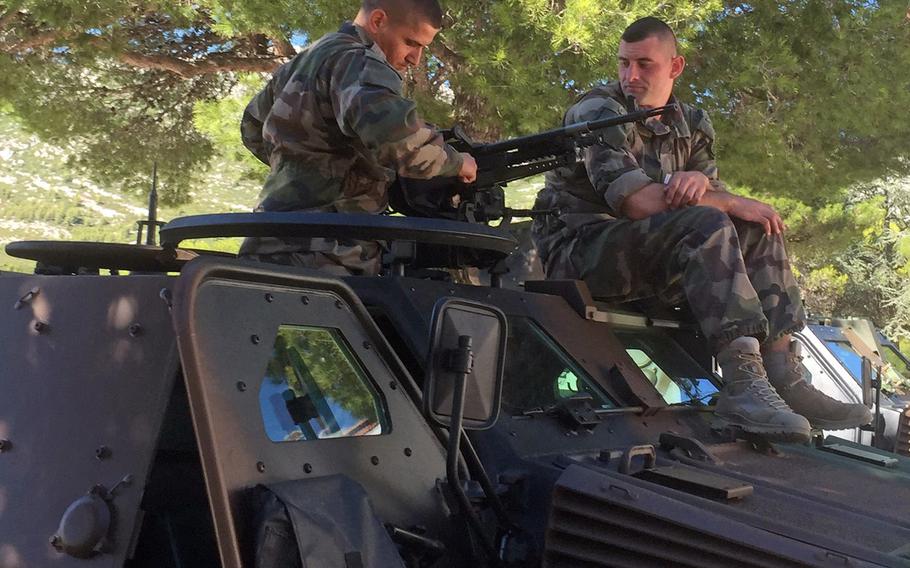 Legionnaires of the 1st Foreign Cavalry Regiment sit on their Panhard VBL armored car at the unit's home base at Camp de Carpiagne on the Mediterranean coast. The light reconnaisence cars pack a punch when equipped with the MILAN anti-tank missiles.