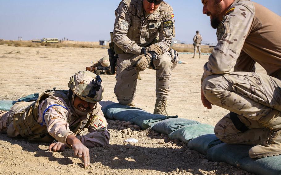NATO soldiers from Spain watch an Iraqi soldier as they go over techniques to detect roadside bombs at the Besmaya Range Complex, Iraq, Feb. 8, 2018. NATO on Wednesday will agree to begin planning for a new training mission in Iraq.