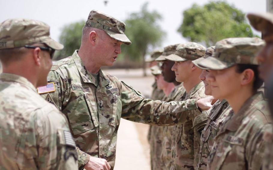 Maj. Gen. Joseph Harrington presents coins to soldiers in a ceremony on April 27, 2017, during a visit to Contingency Location Garoua, Cameroon.