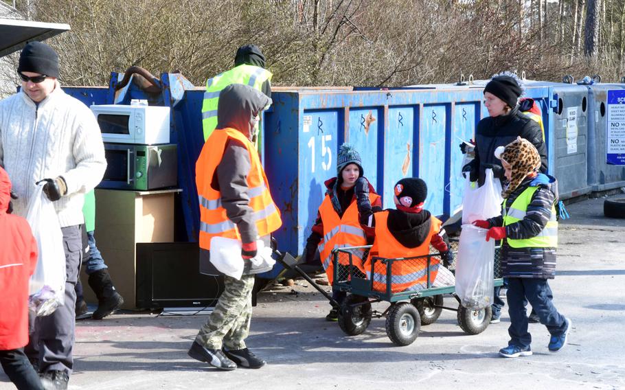 Veterans, soldiers and their families pick up trash at the recycling center at Grafenwoehr, Germany, Saturday, Feb. 24, 2018. 

