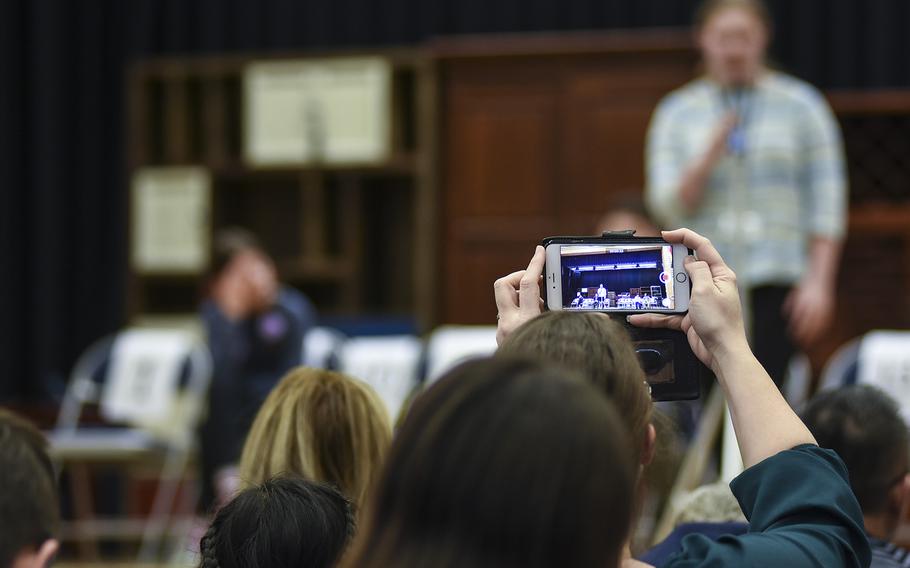 An audience member records with her phone while Sara Moriarity of Naples High School spells a word during the 35th Annual European PTA Spelling Bee on Saturday, March 10, 2018, at Ramstein Air Base, Germany. Moriarity finished third in the contest.