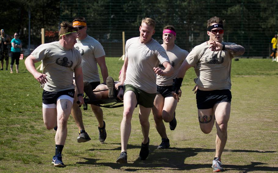 Explosive ordnance disposal airmen from the 786th Civil Engineer Squadron run for the obstacle course finish line during the annual Courage, Leadership, Education, Advocacy and Respect Challenge at Ramstein Air Base, Germany, on Friday, April 20, 2018.
