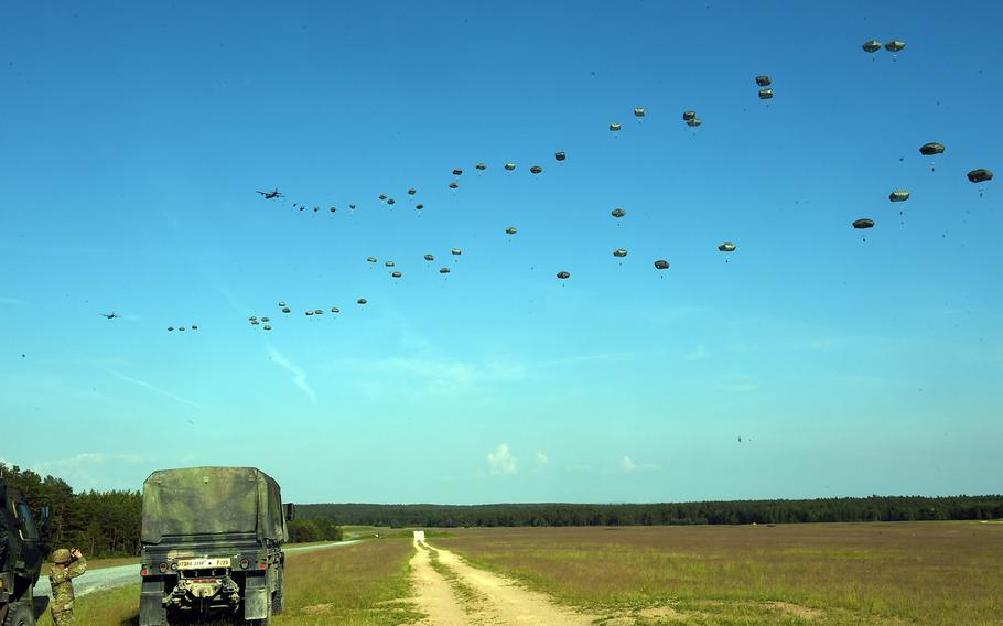Paratroopers with the 173rd Brigade Combat Team (Airborne) jump out of a C-130 Hercules and drop to an artillery live-fire exercise at Grafenwoehr, Germany, Friday, May 18, 2018. 