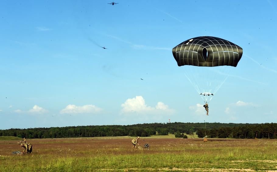Paratroopers with the 173rd Brigade Combat Team (Airborne) drop down and ready their gear for an artillery live-fire exercise at Grafenwoehr, Germany, Friday, May 18, 2018. 
