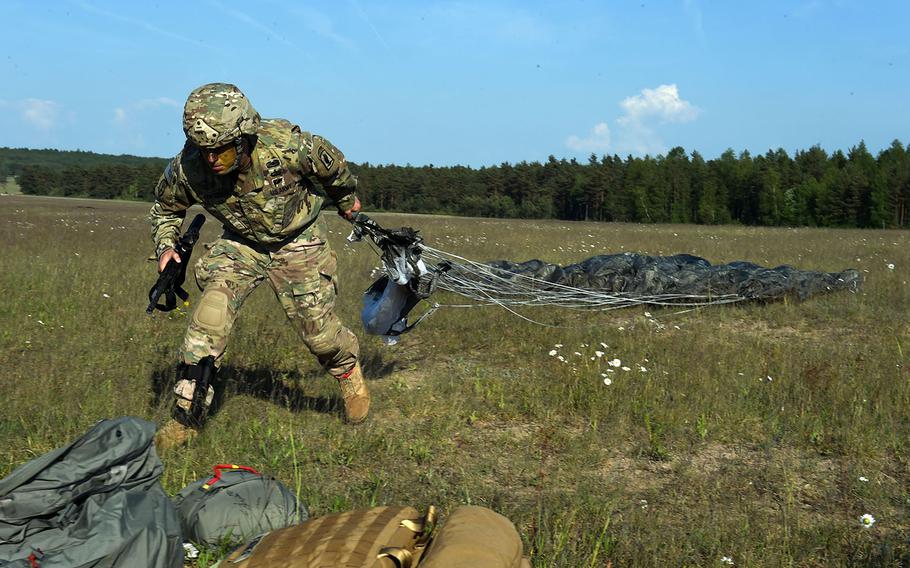 Maj. Michael Centola, executive officer of the 4-319 Field Artillery Regiment, part of the 173rd Brigade Combat Team (Airborne), pulls his parachute toward his pack during a live-fire artillery exercise at Grafenwoehr, Germany, Friday, May 18, 2018. 