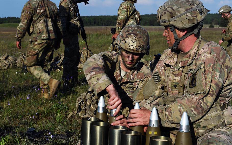Paratroopers with the 173rd Brigade Combat Team (Airborne) get artillery rounds ready for an artillery live-fire exercise at Grafenwoehr, Germany, Friday, May 18, 2018. 