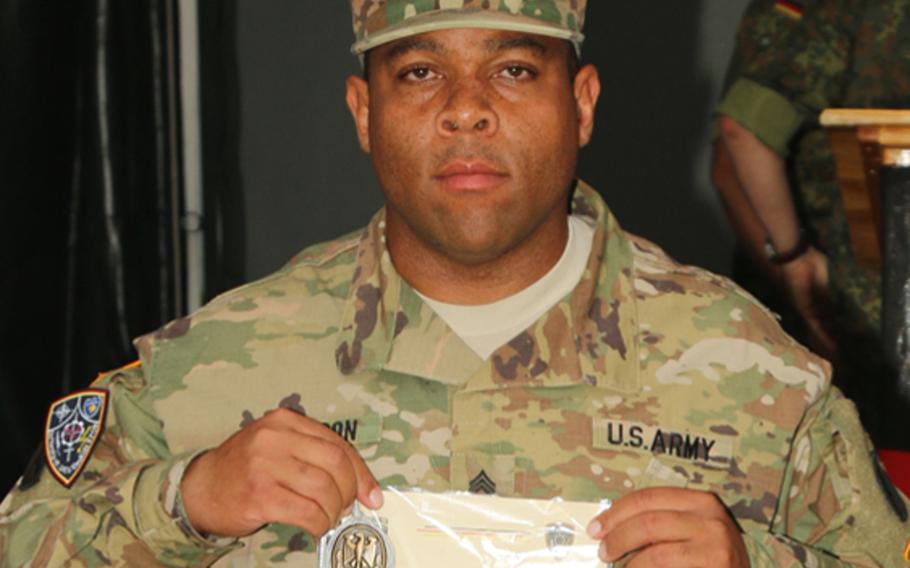 Staff Sgt. Conrad Robinson, left, is pictured here receiving a German Armed Forces Badge of Marksmanship (Schutzenschnur) on May 4, 2018.