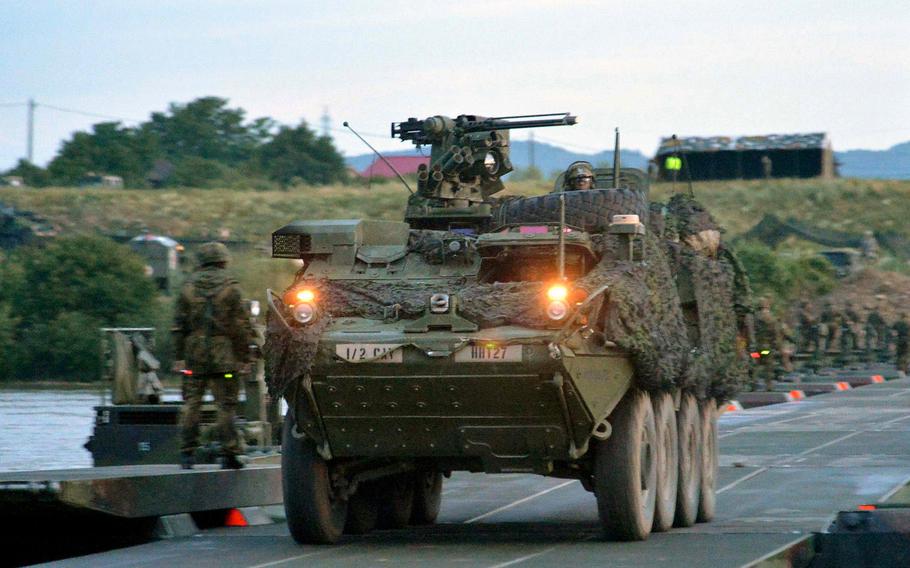 A Stryker of the 2nd Cavalry Regiment crosses a German bridge over the Olt River near Ramnicu Valcea, Romania, in July 2017 during a night river crossing operation. NATO will attempt to boost its combat readiness under a plan to have 30 mechanized battalions, 30 air squadrons and 30 combat ships that can deploy within 30 days.

