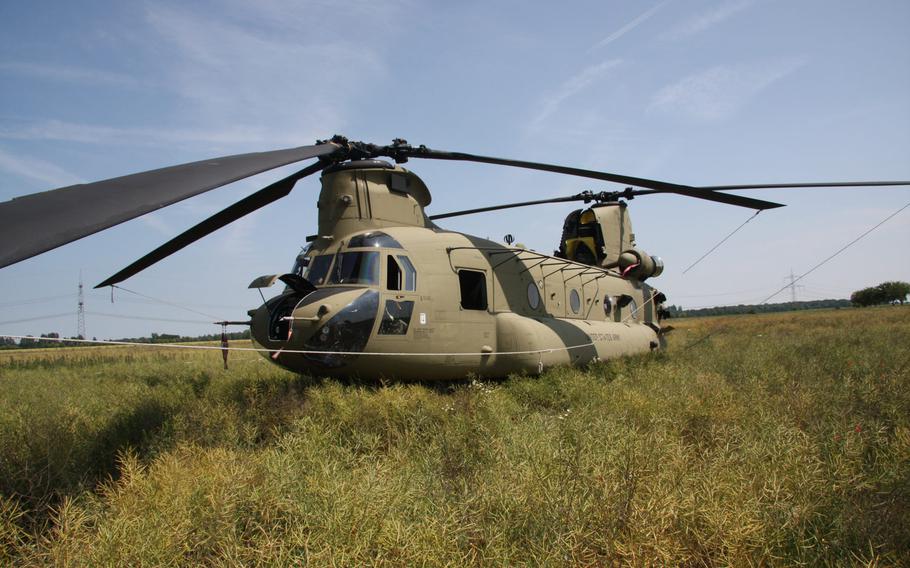 A U.S. Army CH-47 Chinook stands in a field awaiting repairs after it made an emergency landing near the eastern German town of Delitzsch on Monday, June 4, 2018.