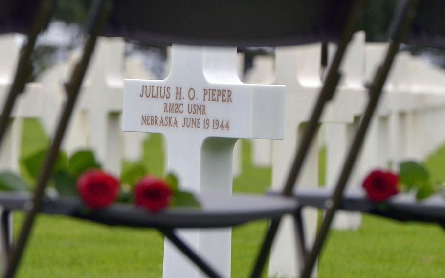 Roses that family members will place on the coffin of Julius “Henry” Pieper during his memorial service lie of chairs next to his headstone at Normandy American Cemetery in Colleville-sur-Mer, France, Tuesday, June 19, 2018. 


