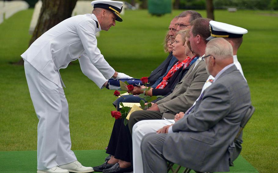 Rear Adm. Shawn E. Duane, vice commander, U.S. Sixth Fleet, presents the flag that covered the coffin of Julius “Henry” Pieper to his niece Linda Pieper Suitor during a memorial at Normandy American Cemetery in Colleville-sur-Mer, France, Tuesday, June 19, 2018. 



