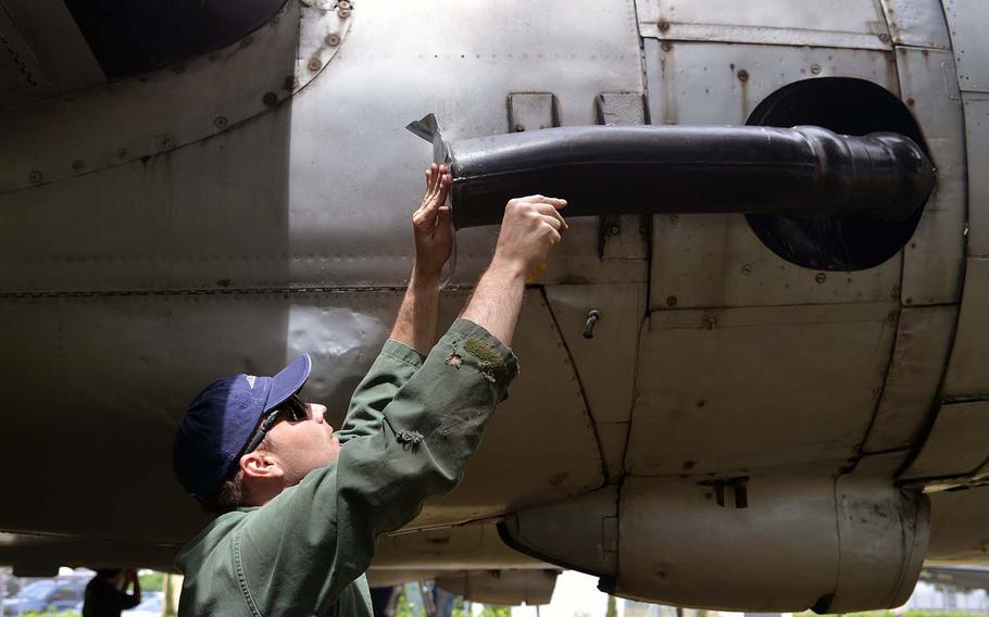 Tech Sgt. Chris Blank makes repairs to the C-54 Skymaster at the Berlin Airlift Memorial near Frankfurt, Germany. Ten airmen from Ramstein Air Base's 86th Maintenance Squadron volunteered to patch up the aging aircraft ahead of Tuesday's 70th anniversary of the airlift. 



