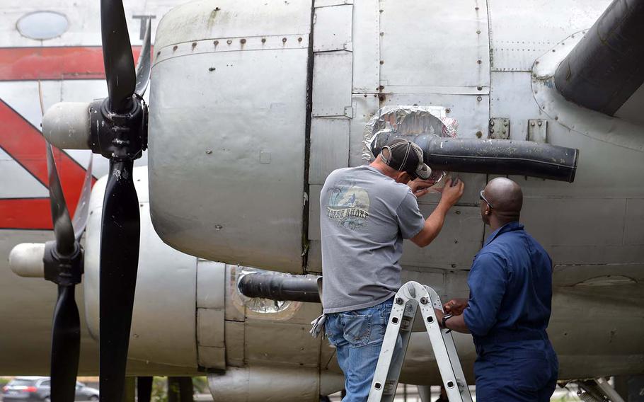 Senior Master Sgt. Billy Brown, left, and Maj. Brandon Ray of Ramstein Air Base's 86th Maintenance Squadron patch up the the C-54 Skymaster at the Berlin Airlift Memorial near Frankfurt, Germany, Saturday, June 23, 2018. 



