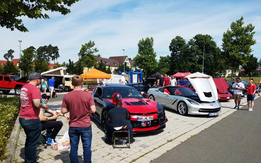 Soldiers and families check out cars on display at the Independence Day car show at Grafenwoehr, Germany, Wednesday, July 4, 2018. 