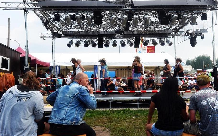 Germans and Americans try line dancing at the German-American Volksfest at Grafenwoehr, Germany, Friday, Aug. 3, 2018. 

