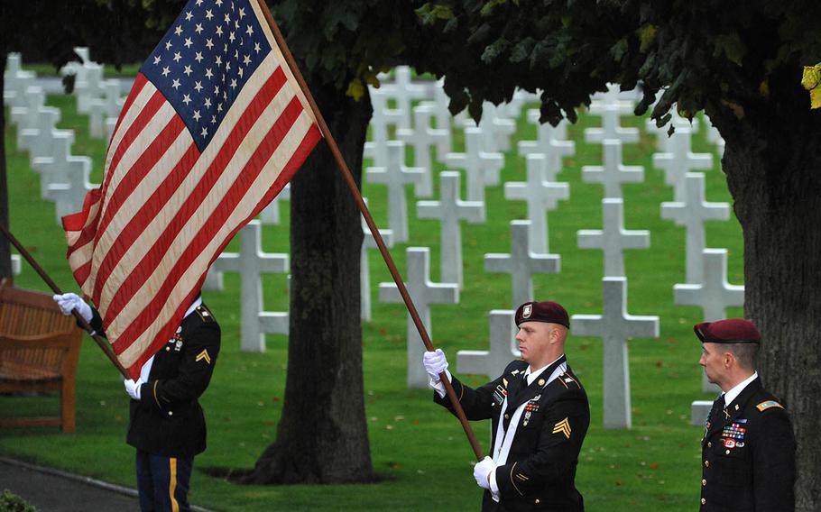 A U.S. Army soldier holds the American flag during the World War I armistice centennial ceremony, at Suresnes American Cemetery  Sunday, Nov. 11, 2018. 


