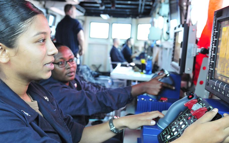 Petty Officers 2nd Class Alma Gallegos, left, and Kjae Robinson, right, assigned to the submarine tender USS Emory S. Land, operate MK-38 weapons systems during the 24th annual Cooperation Afloat Readiness and Training exercises in the South China Sea, Nov. 15, 2018. The Navy will roll out new performance reports which will gather input from subordinates and peers.
