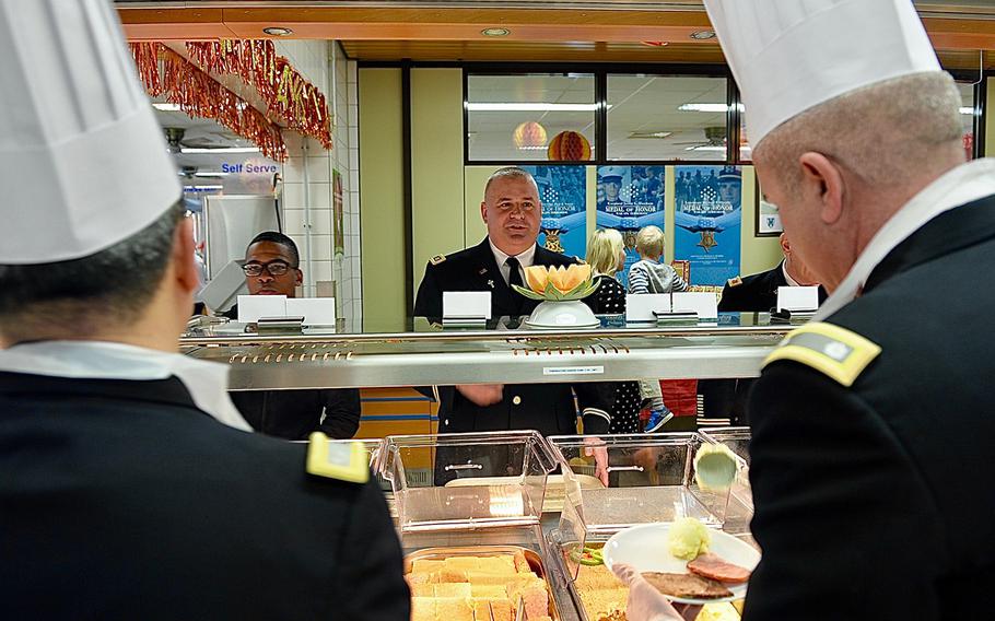 An Army chaplain decides what to eat on Thanksgiving Day in the serving line of the Clock Tower Cafe at Kleber Kaserne in Germany.