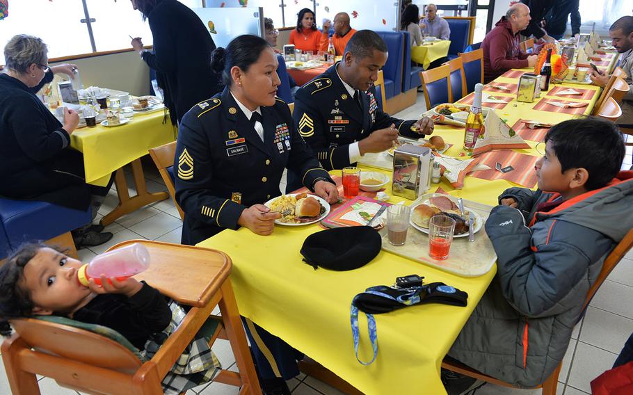 The Salnaves, Sgt. 1st Class Stephane Salnave his wife Master Sgt. Karie Salvane, eat Thanksgiving Dinner with their infant daughter and son at the Clock Tower Cafe dinning facility on Kleber Kaserne in Germany.