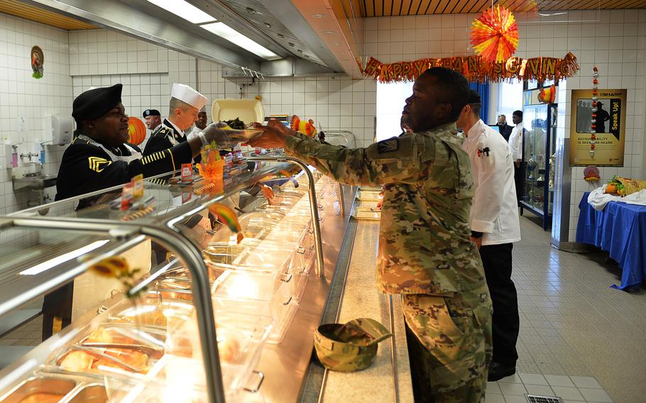 Staff Sgt. Terrell Price picks up a carryout container and returns to duty on Thanksgiving Day at Kleber Kaserne in Germany. 