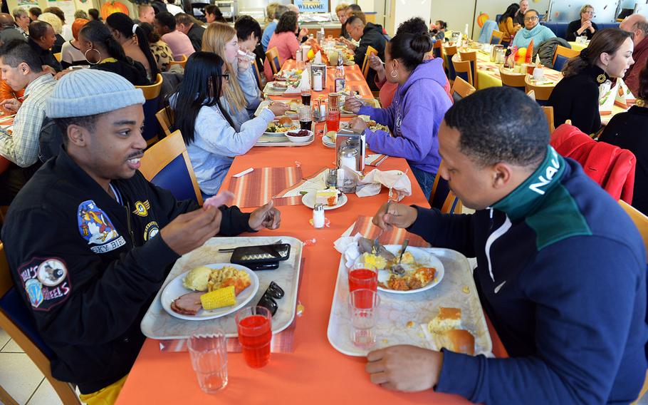 Army Sgt. Lavalle Roberts of the 624th Movement Control Team and Pvt. Toure Watson of the 635th Movement Control Team eat Thanksgiving Day dinner together at the Clock Tower Cafe on Kleber Kaserne in Germany.