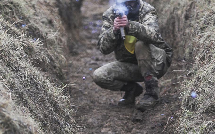 A Ukrainian Soldier fires a paintball gun during the Best Platoon Competition at the International Peacekeeping and Security Centre, Ukraine, last week.