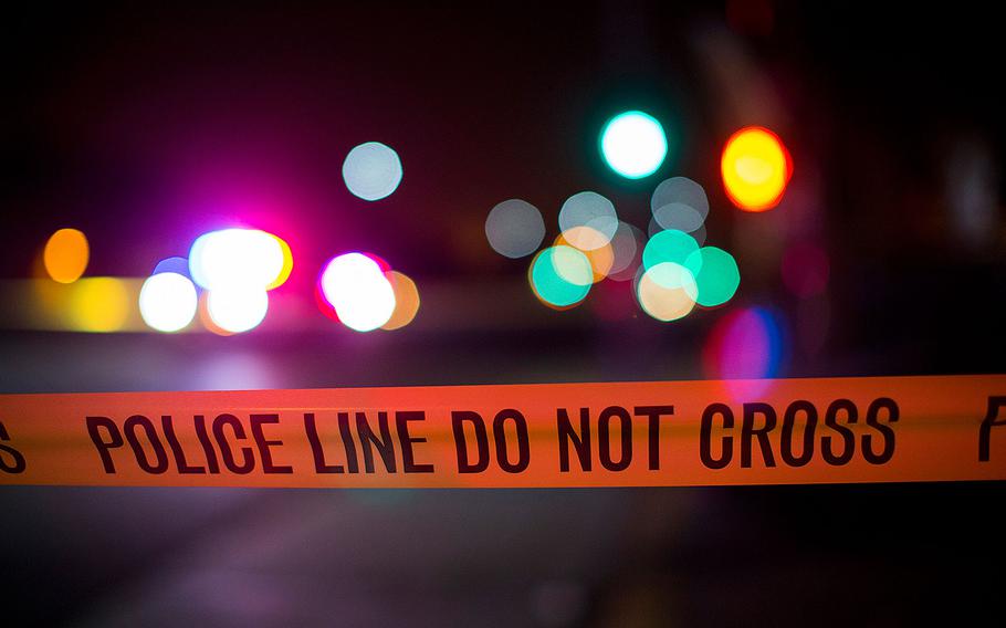 Neon lights twinkle above police line tape at an intersection on Aug. 10, 2016 in San Bernardino, Calif. 