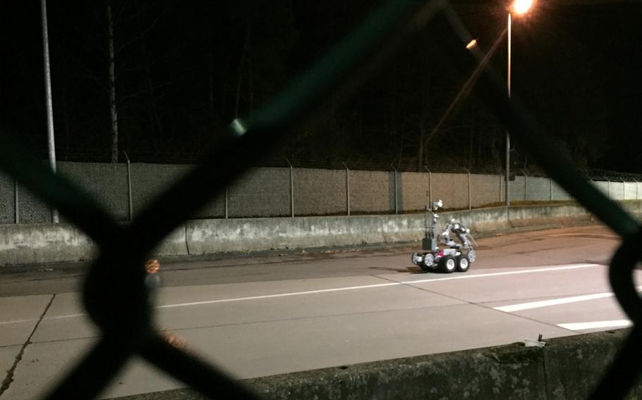 A remotely operated bomb disposal robot prepares to inspect a vehicle driven by a retiree who purportedly made reference to a bomb in his car at Kleber Kaserne, Germany. According to base officials, the 83-year-old Army veteran refused to let security guards do a random search of his vehicle and then made a threat.