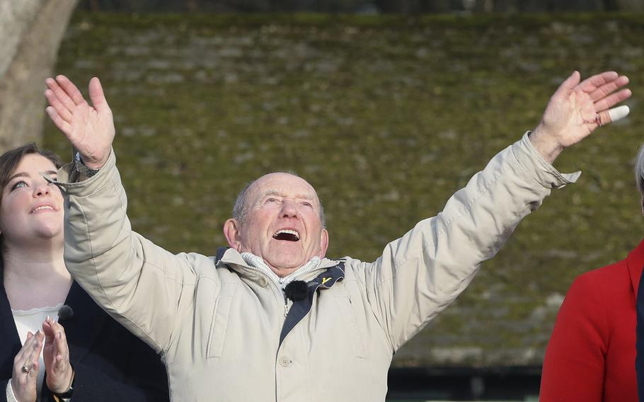 Tony Foulds, 82, waves from Endcliffe Park in Sheffield, as warplanes from Britain and the United States stage a joint flypast tribute to ten US airmen Friday Feb. 22, 2019, 75-years after Foulds witnessed the crash that killed them.