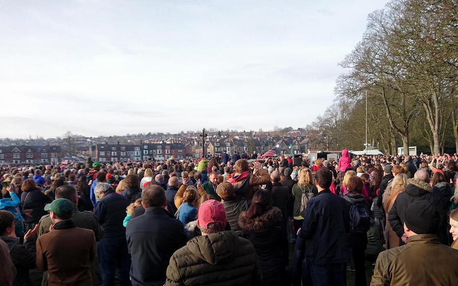 A crowd watches a flyover Friday Feb. 22, 2019, that pays tribute to U.S. airmen killed in a World War II plane crash.