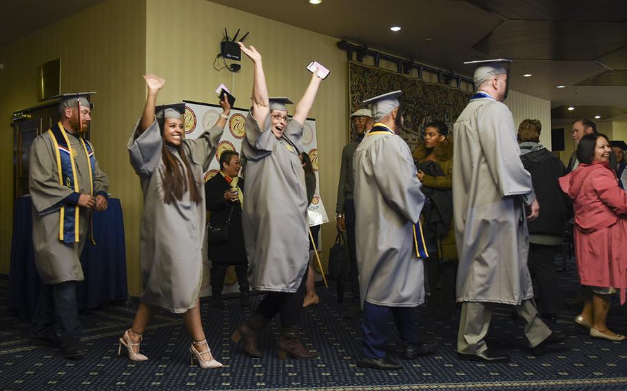 UMUC Europe graduates celebrate while lining up for commencement on Saturday, May 4, 2019, at Ramstein Air Base, Germany.