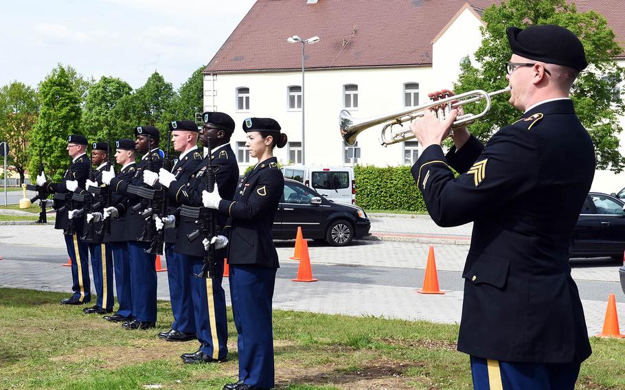 A trumpeter plays taps while soldiers present arms during a ceremony to rededicate memorial to fallen soldiers from the 18th Military Police Brigade, Thursday, May 23, 2019, at Vilseck, Germany. 