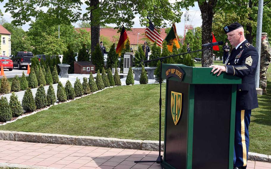 Sgt. Maj. Ted Pearson, with the 18th Military Police Brigade, speaks to his soldiers during a ceremony to rededicate a memorial to fallen soldiers from their brigade, Thursday, May 23, 2019, at Vilseck, Germany. 

