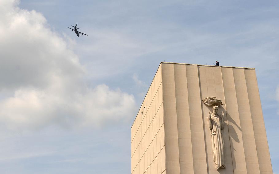 A C-130 of the 86th Airlift Wing out of Ramstein Air Base, Germany, flies over the memorial chapel at Lorraine American Cemetery in St. Avold, France, Sunday, May 26, 2019, during the Memorial Day ceremony held there.