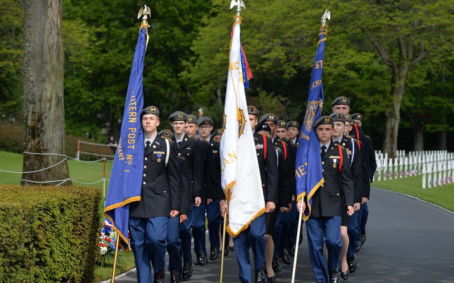 The Stuttgart High School JROTC unit marches in for the Memorial Day ceremony at Lorraine American Cemetery in St. Avold, France, Sunday, May 26, 2019.