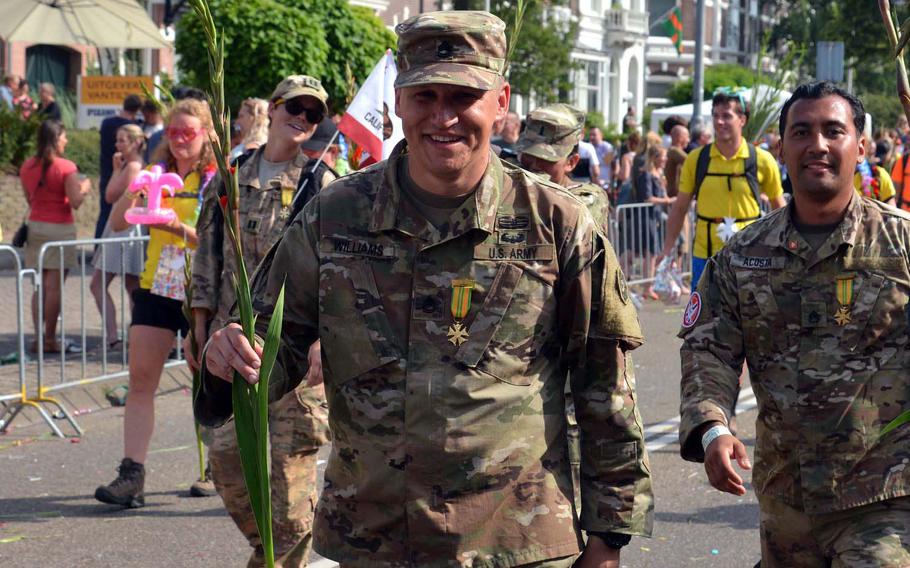Wearing his Vierdaagsekruis and carrying a traditional gladiolus, Sgt. 1st Class Joshua Williams of the 5th Military Police Battalion out of Kaiserslautern, Germany, and other U.S. servicemembers walk up the so-called Via Gladiola in Nijmegen, Netherlands, Friday, July 19, 2019. 