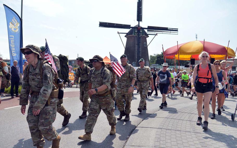 Servicemembers and civilians pass by the windmill at Groesbeek, Netherlands, on the third day of the Nijmegen Four Days Marches, Thursday, July 18, 2019. Close to 6,000 military marchers, including 450 Americans, joined the 40,000-plus civilians in the marches