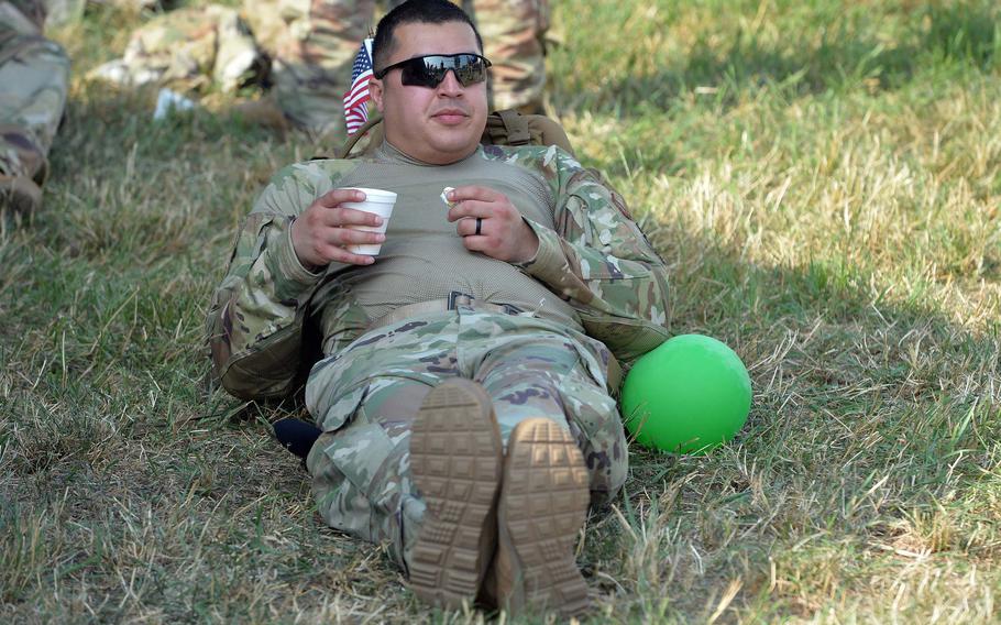Staff Sgt. Alfredo Gutierrez, from Vokel Air Base, Netherlands, takes a break at a rest area in Milsbeek on the third day of the Nijmegen Four Days Marches, Thursday, July 18, 2019.