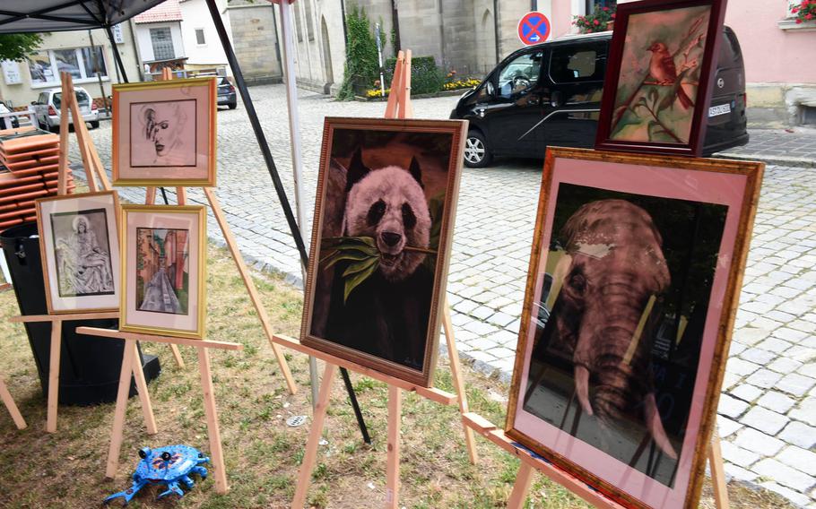 Paintings by personnel stationed at the Tower Barracks are displayed at a festival in Grafenwoehr, Germany, Sunday, July 28, 2019. 
